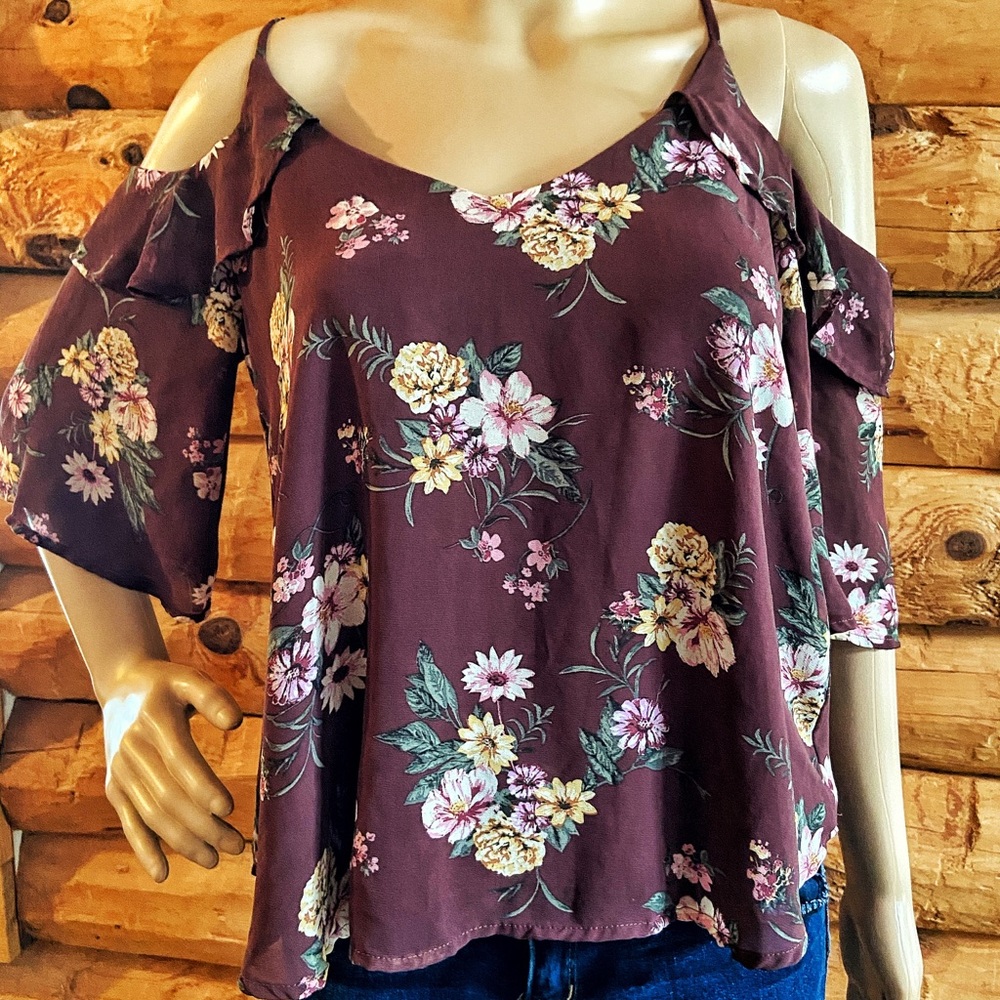 Purple off-the-shoulder blouse with floral details